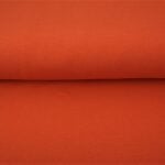 Folded roll of bright orange fabric material