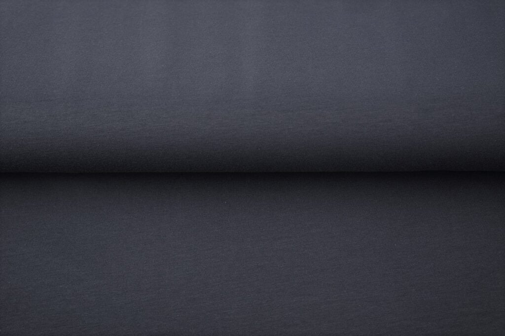 Folded dark grey fabric textile material closeup