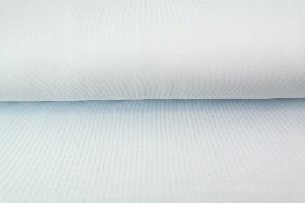 Folded light blue cotton fabric material