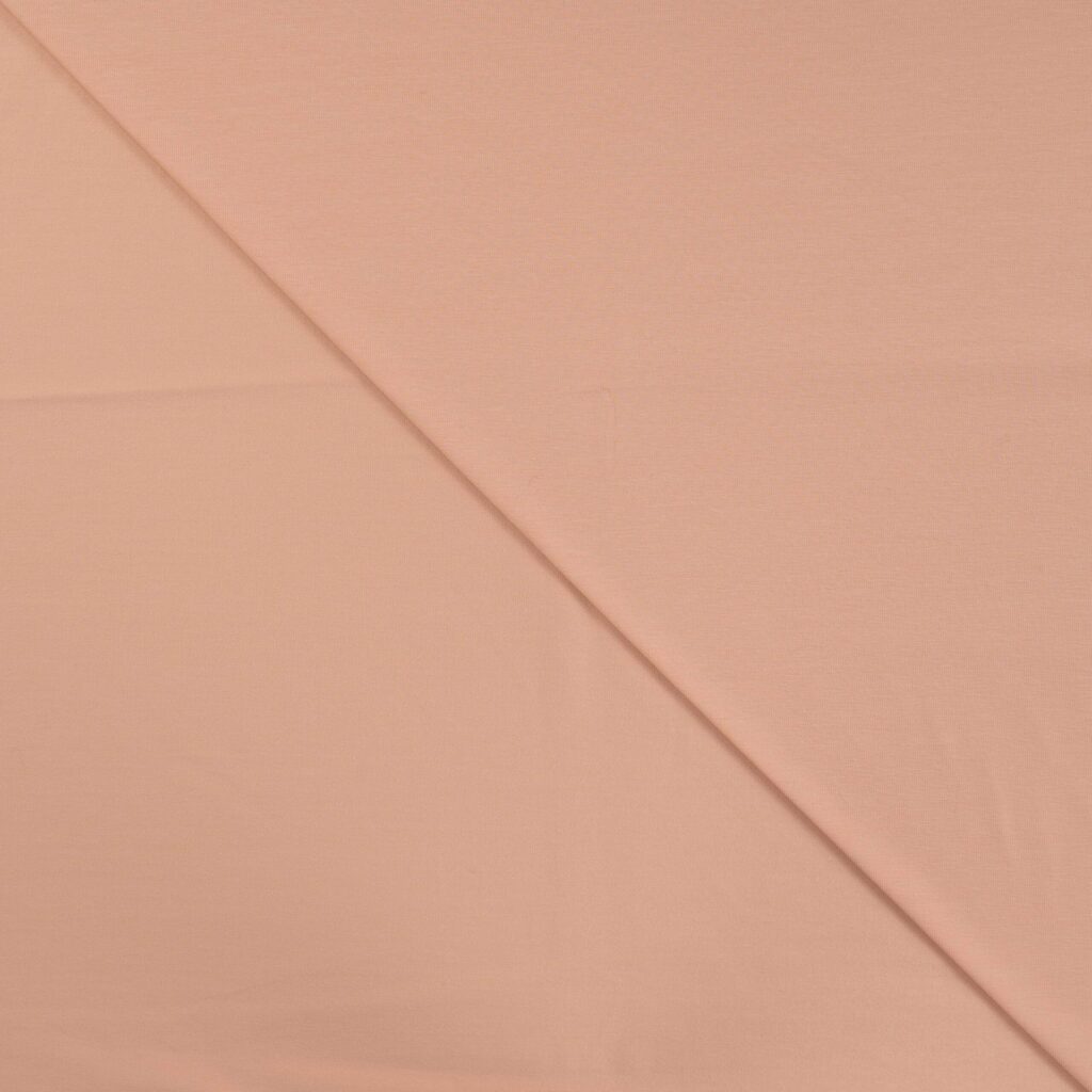 Peach pink cotton fabric folded diagonally