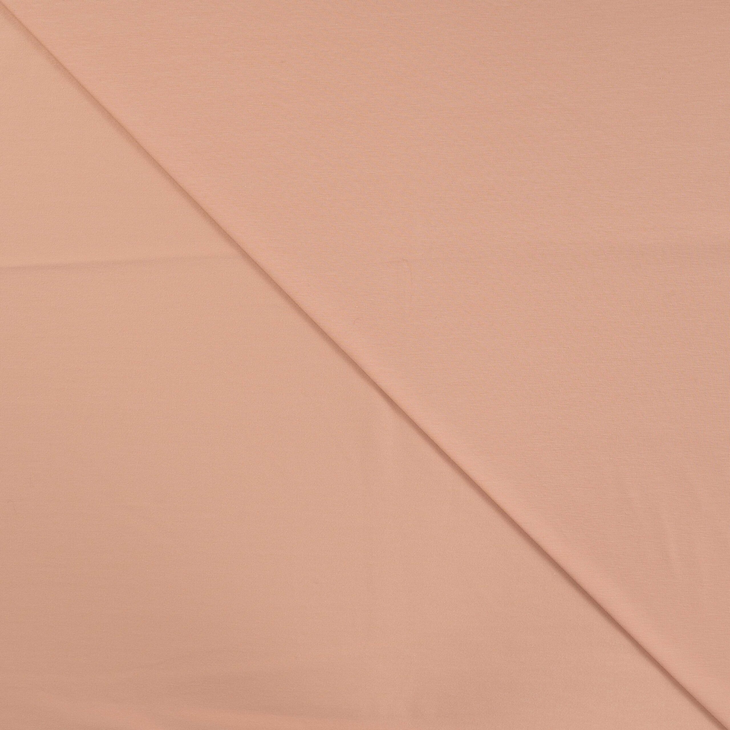 Peach pink cotton fabric folded diagonally