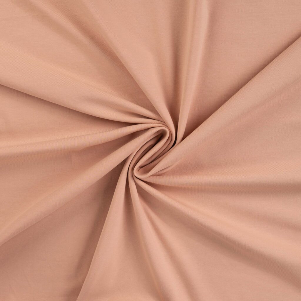 Beige cotton fabric with swirl fold pattern