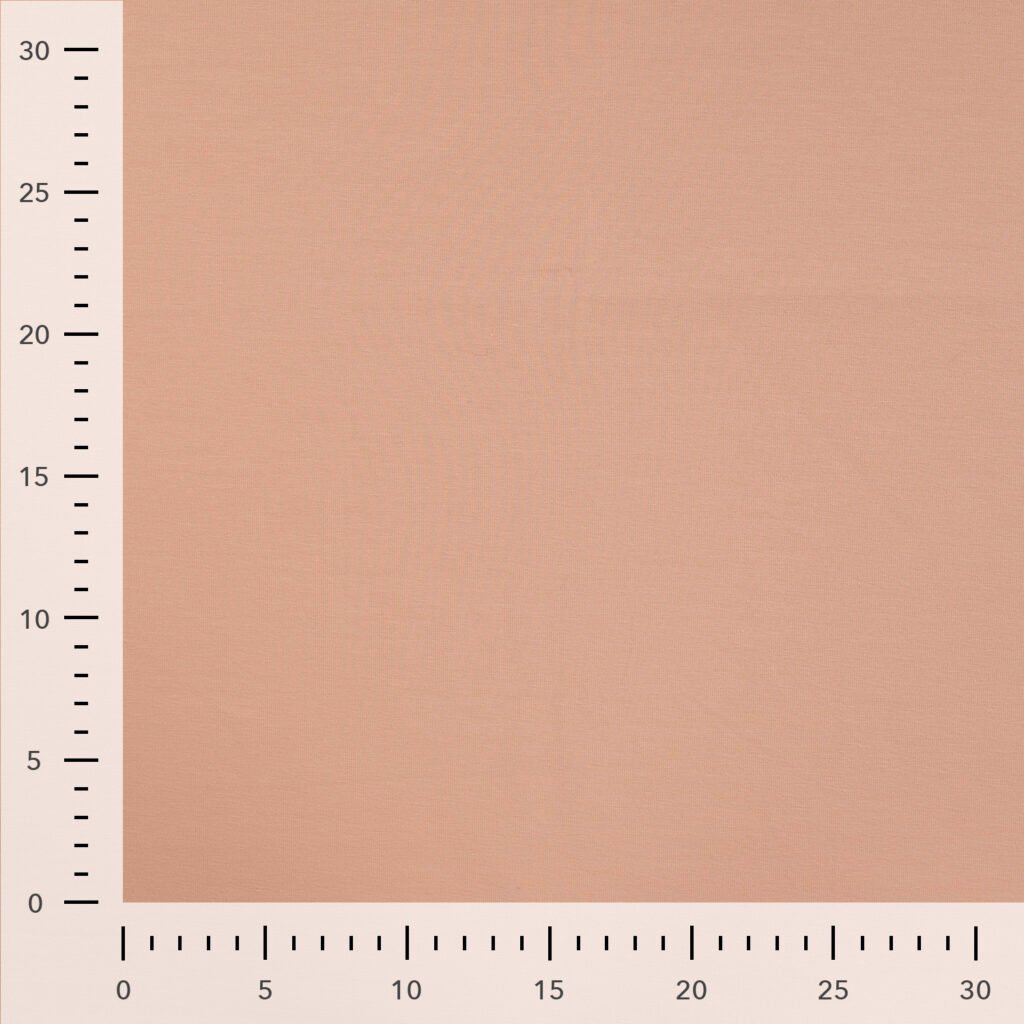 Beige fabric sample with measurement scale.
