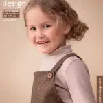 Naeratav laps sügisese moeajakirja kaanel