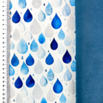 Siniste vihmapiiskade mustriga kangas ja joonlaud