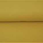 Kollane puuvillane kangas rullis