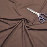 Brown fabric with scissors on top