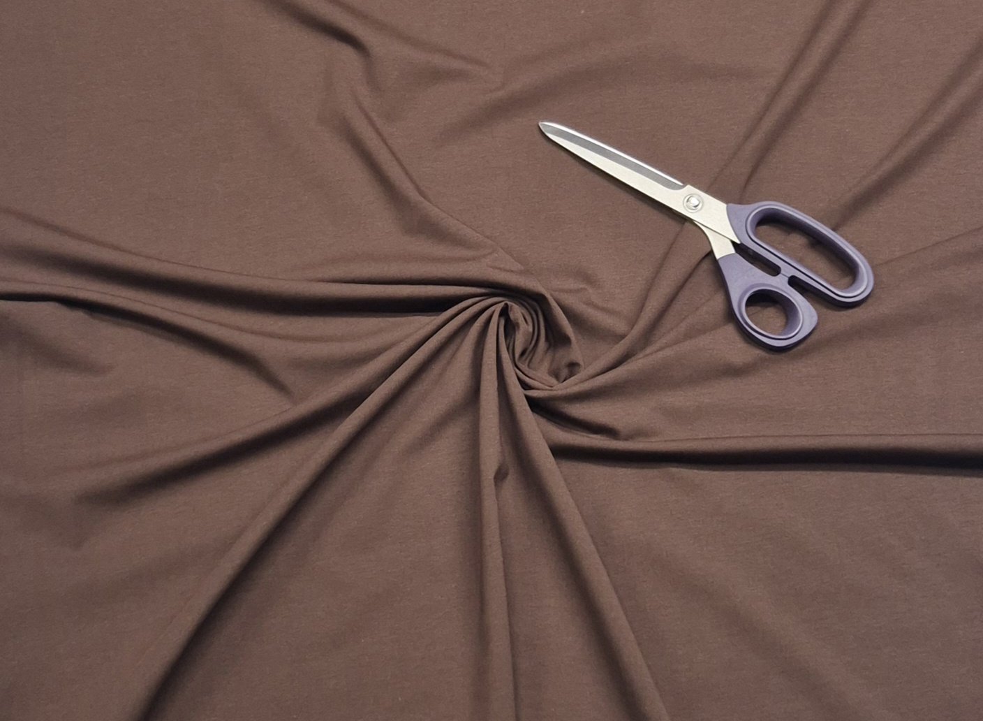 Brown fabric with scissors on top