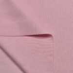 Folded pink ribbed fabric texture close-up