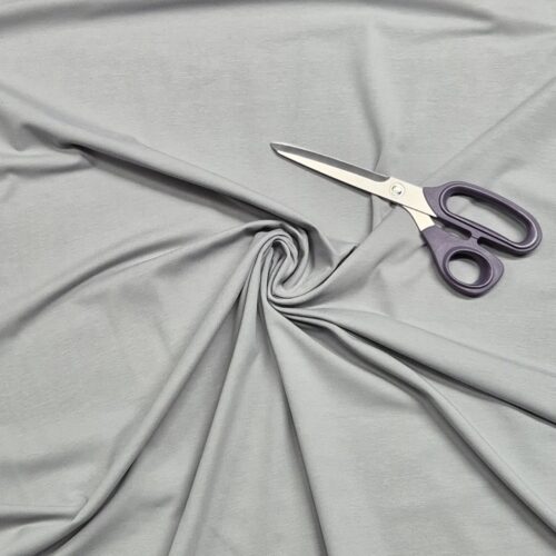 Gray fabric with purple-handled scissors