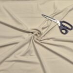 Beige fabric swirl with scissors on top