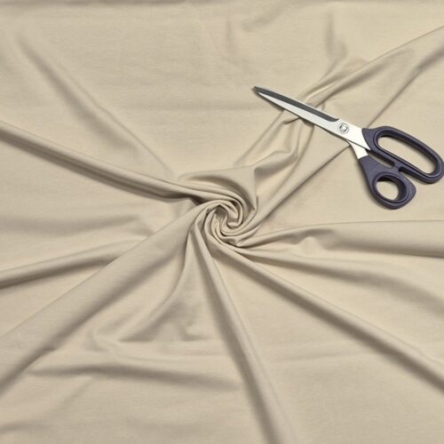 Beige fabric with scissors on top