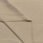 Beige ribbed fabric folded to show texture