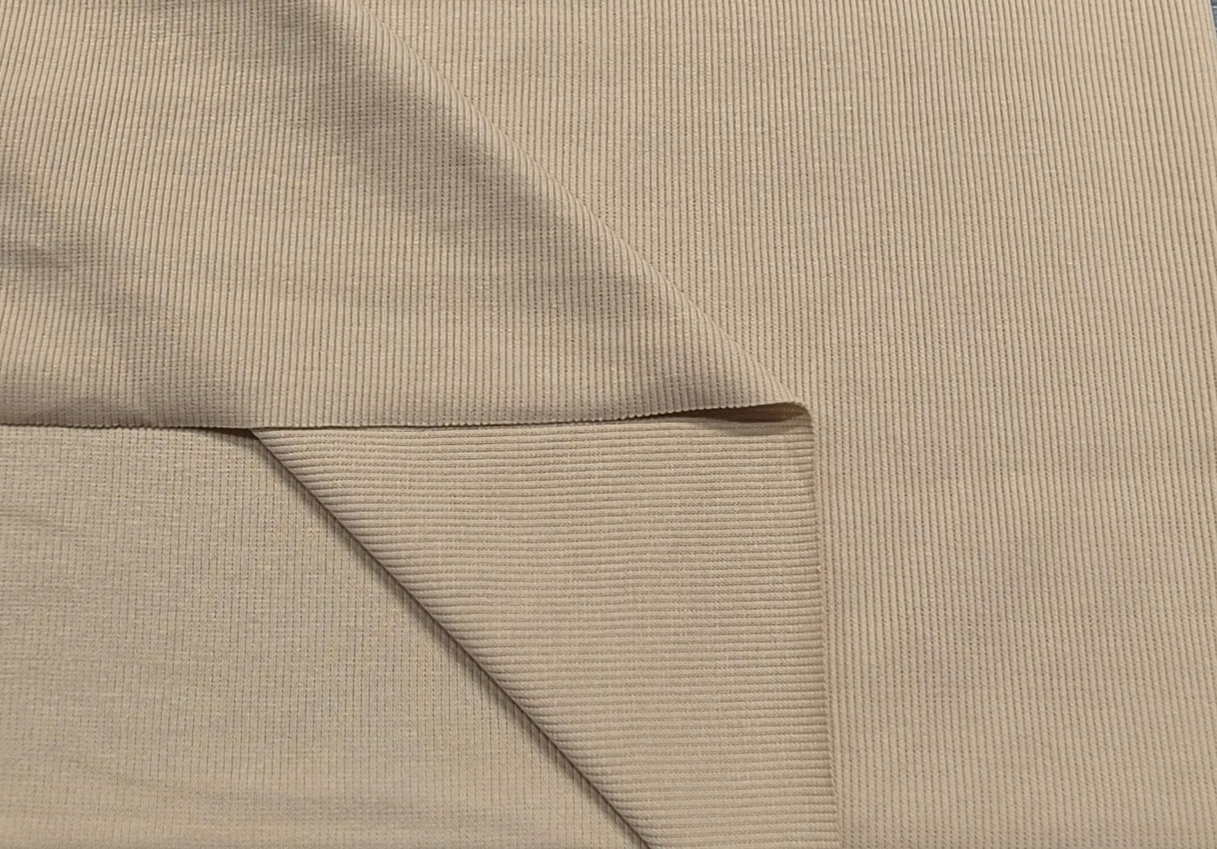 Beige ribbed fabric folded to show texture