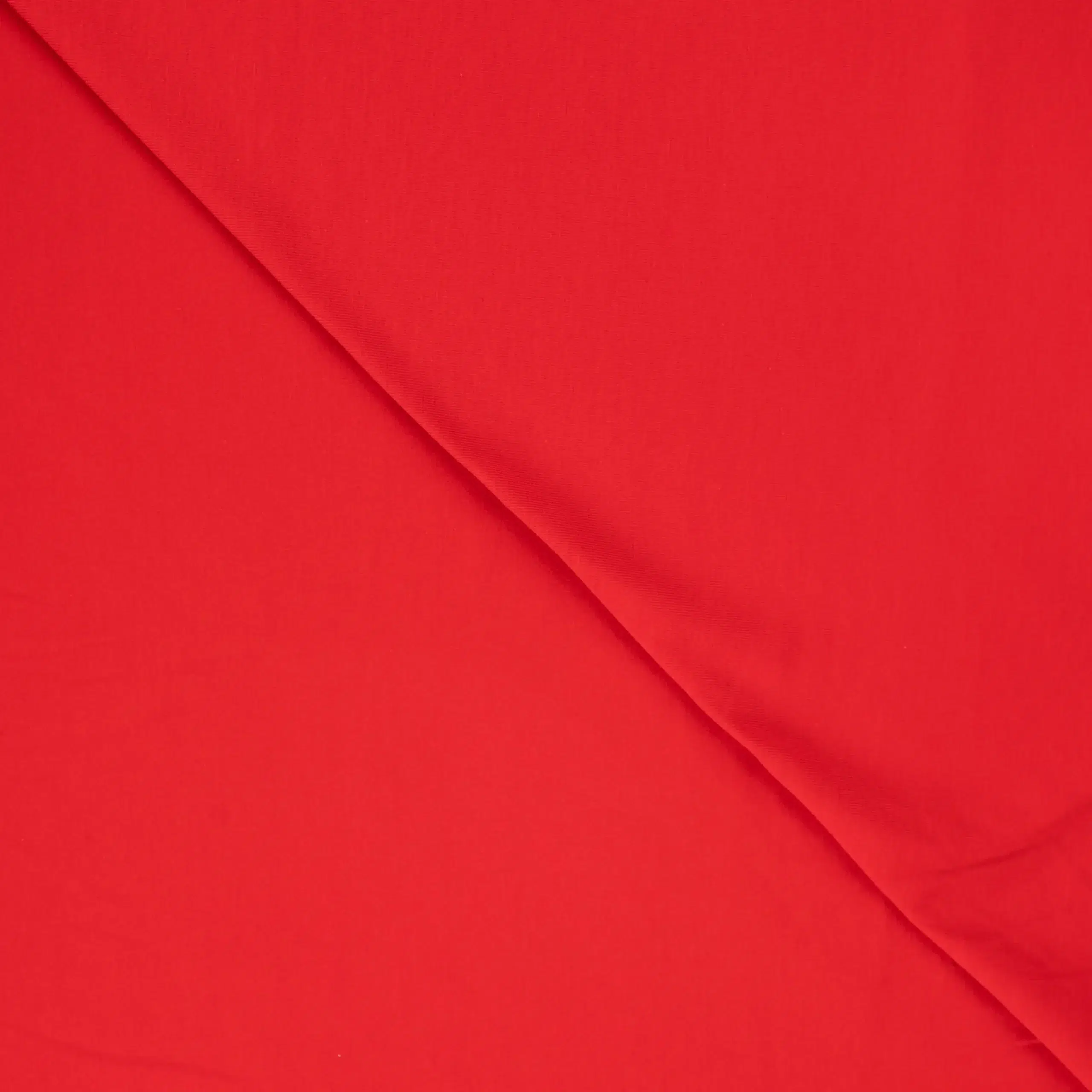 Close-up of red fabric with diagonal fold