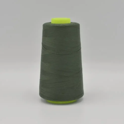 Dark green thread spool on white background