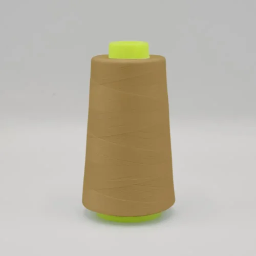 Cone of tan thread with green spool