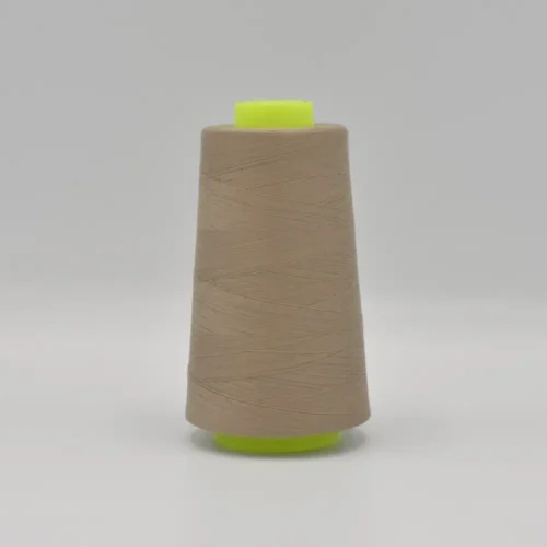 Beige thread cone on neon green spool